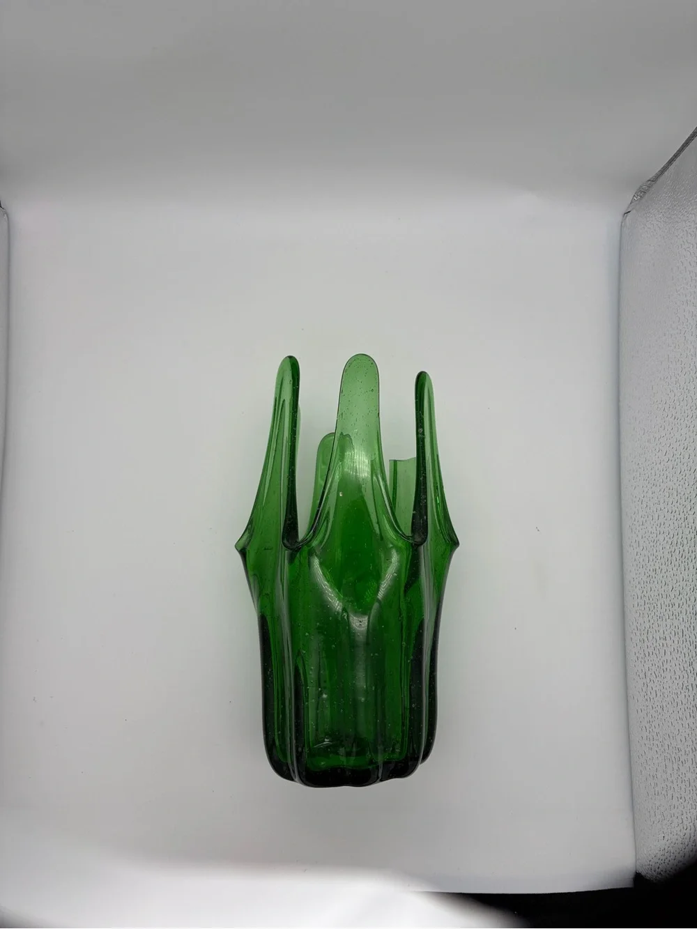 Vintage green swing glass vase with purple lily trumpet flowers.